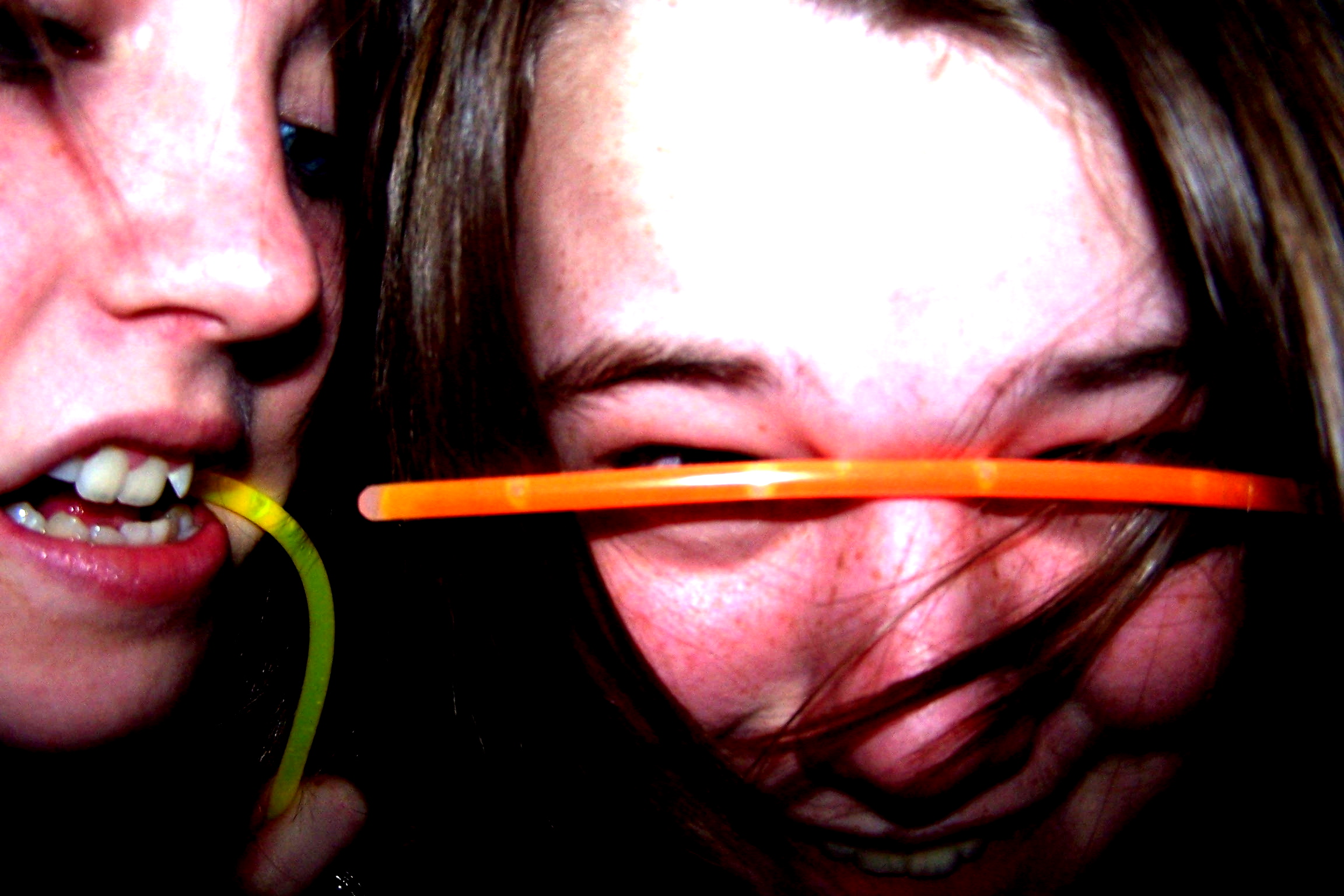 two girls are brushing their teeth with an electric toothbrush