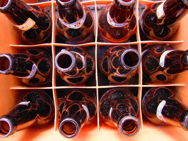 a bunch of different bottles with brown tops