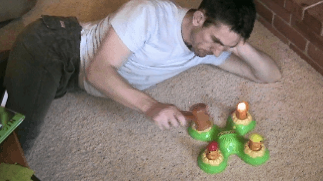 a man laying on the floor with his toy alligators
