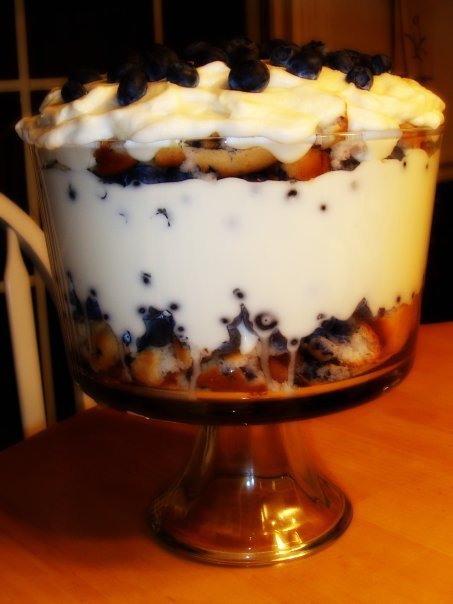 a dessert with whipped cream and cookies in a glass bowl