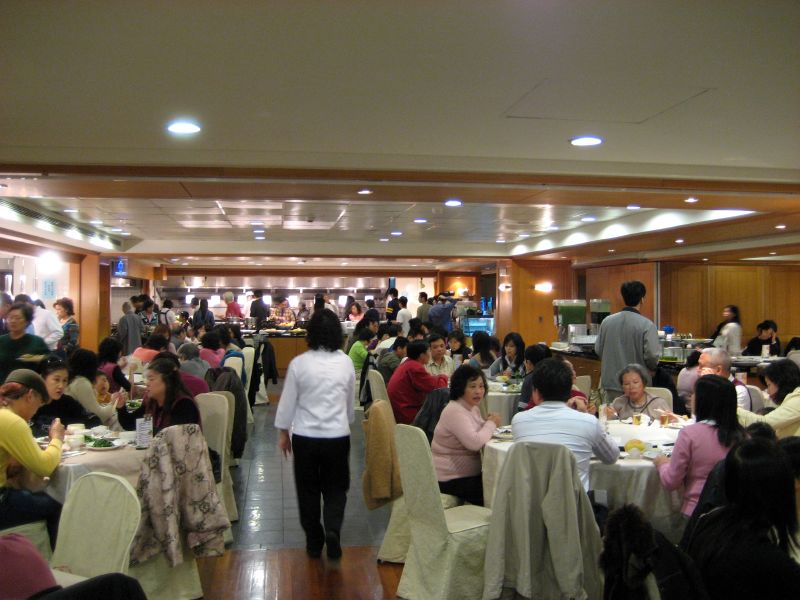 a large room full of people sitting at tables