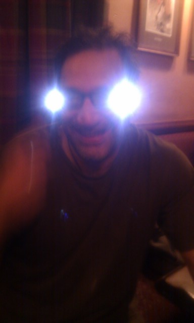 a man wearing glowing glasses in a living room