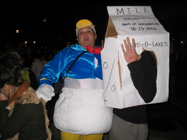 a man wearing a white mask holding a white paper bag