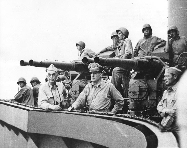 a black and white po shows a group of men on a boat looking at a large cannon
