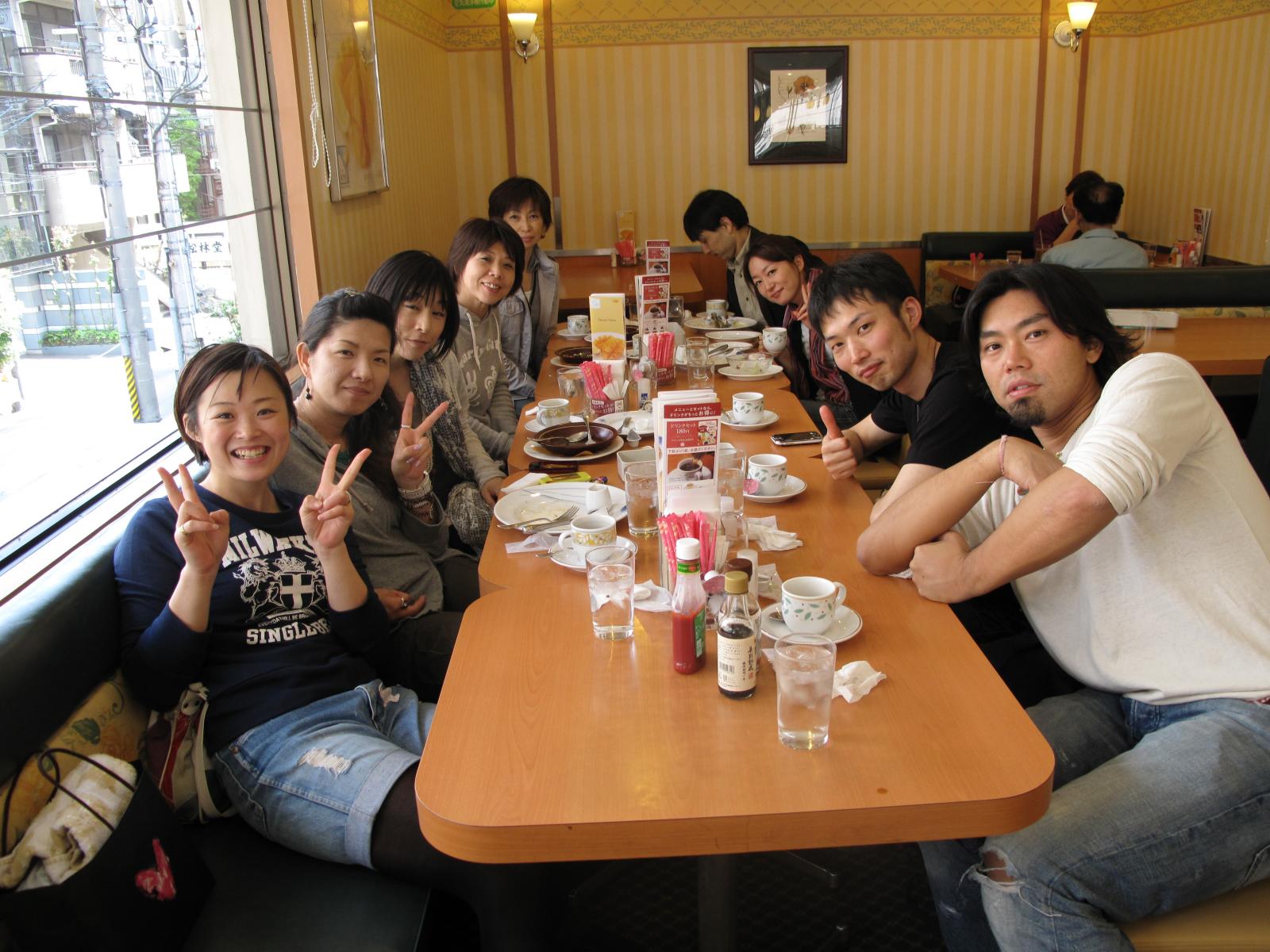 a group of people pose for a picture at a restaurant table