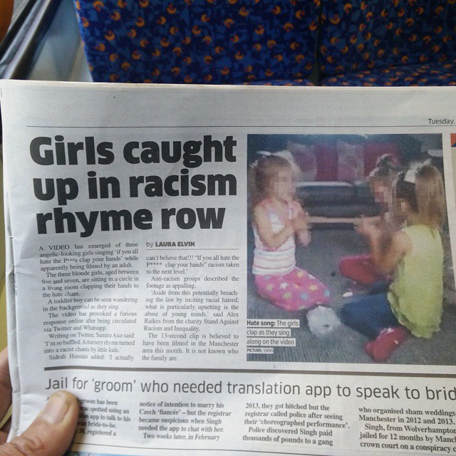 the newspaper has an image of two girls arguing in racism