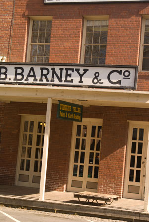 a brick building with white doors and signs