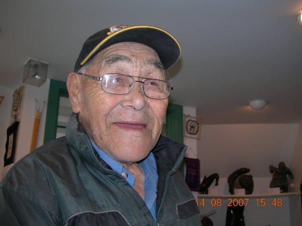 an old man with glasses and a hat on