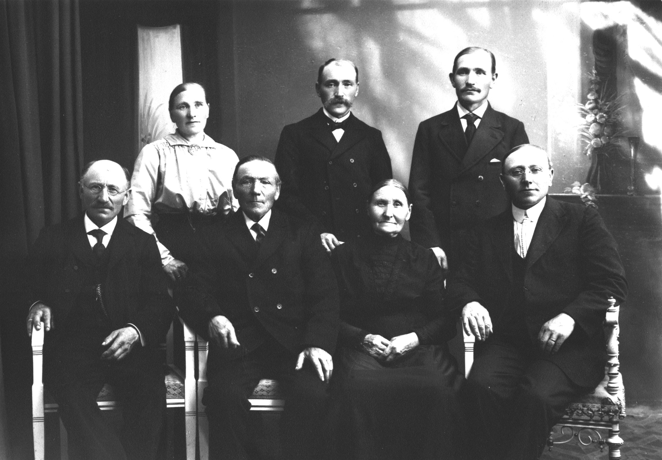 a group of people in formal attire sitting next to each other