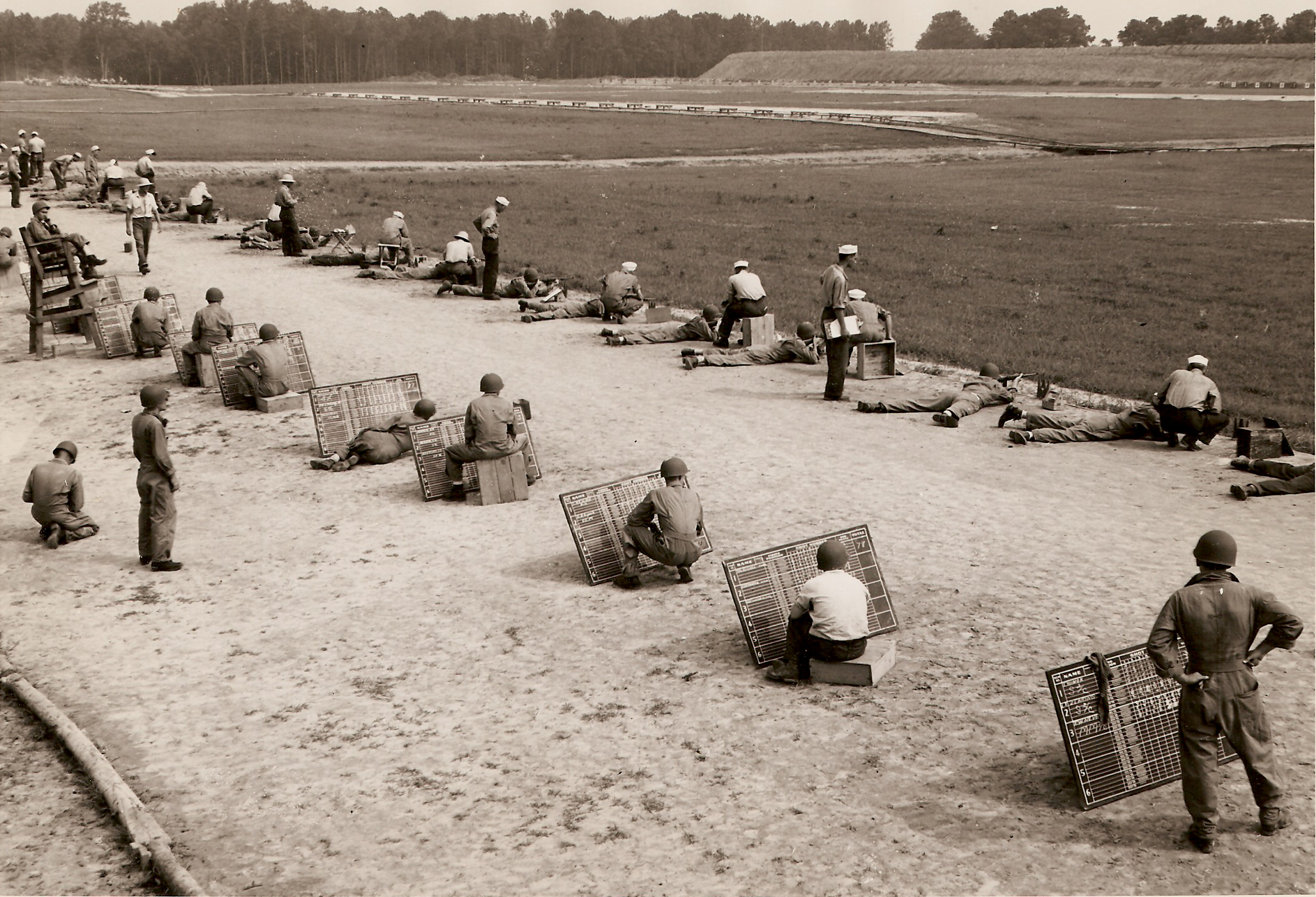 an old black and white po of men sitting in a field