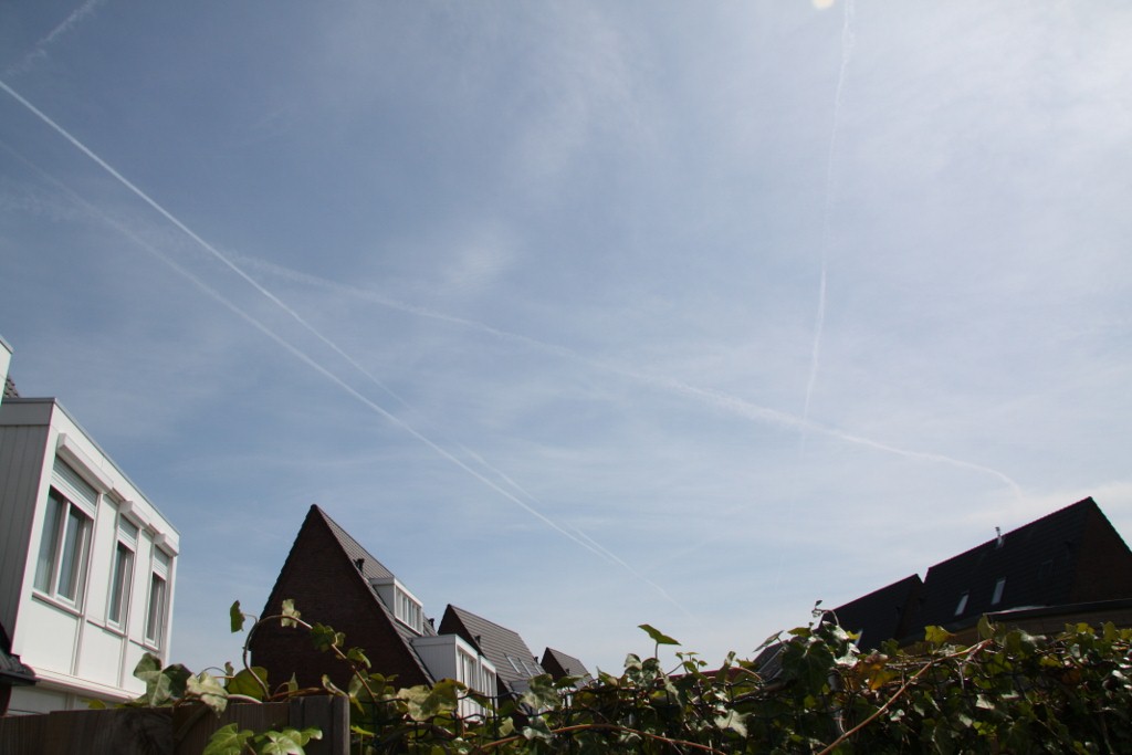 an image of a cloudy sky above a row of houses