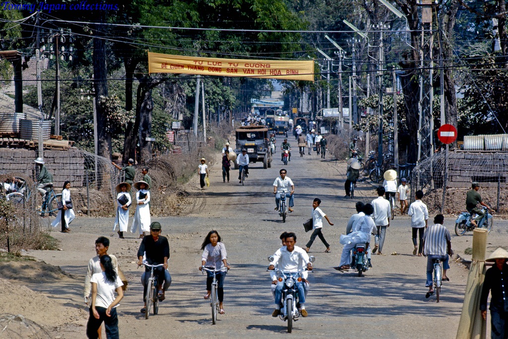 a large group of people walking and riding bicycles