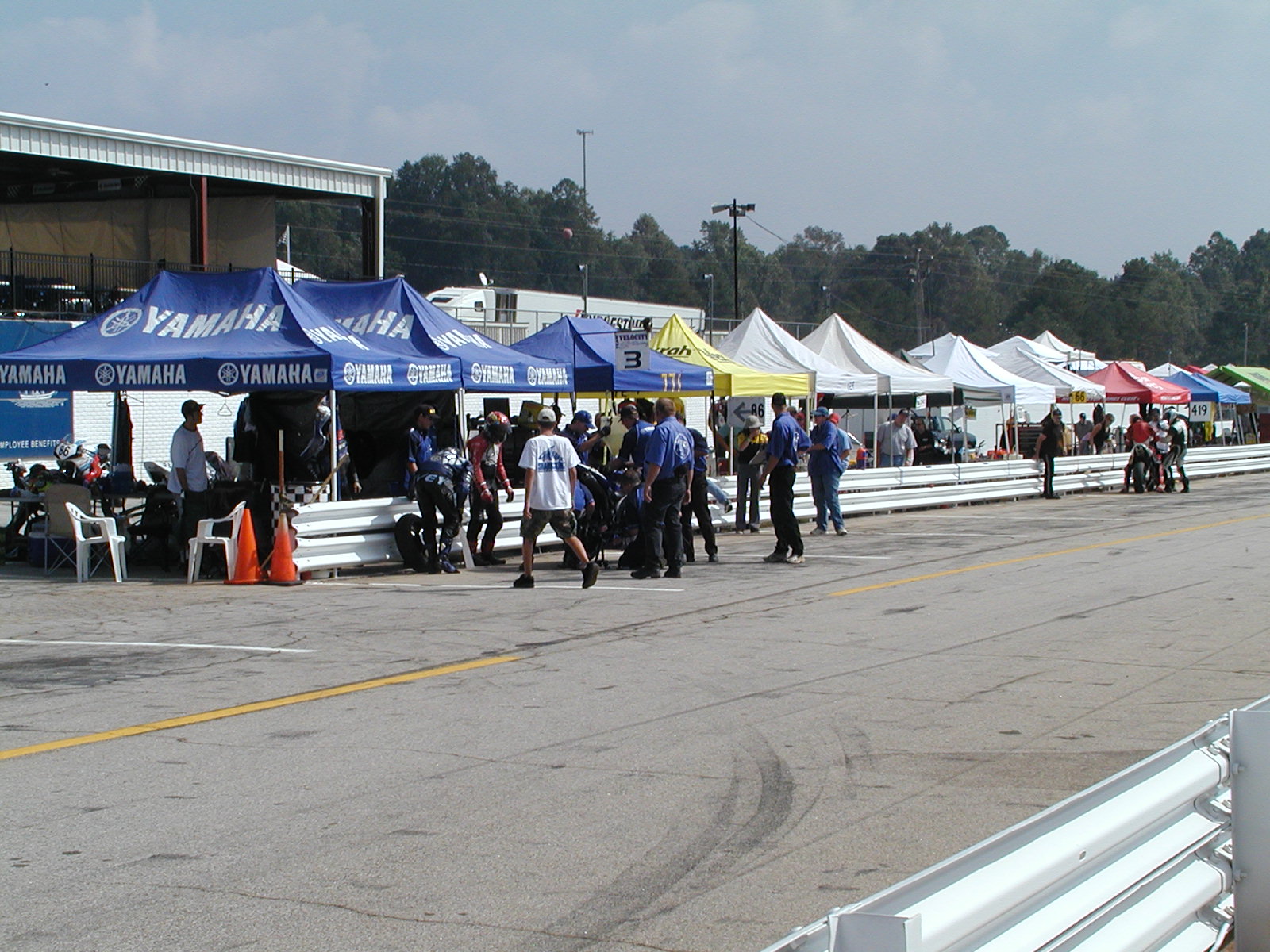 several tents set up on the side of a race track