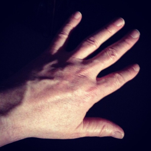a hand is spread out to stretch out the light