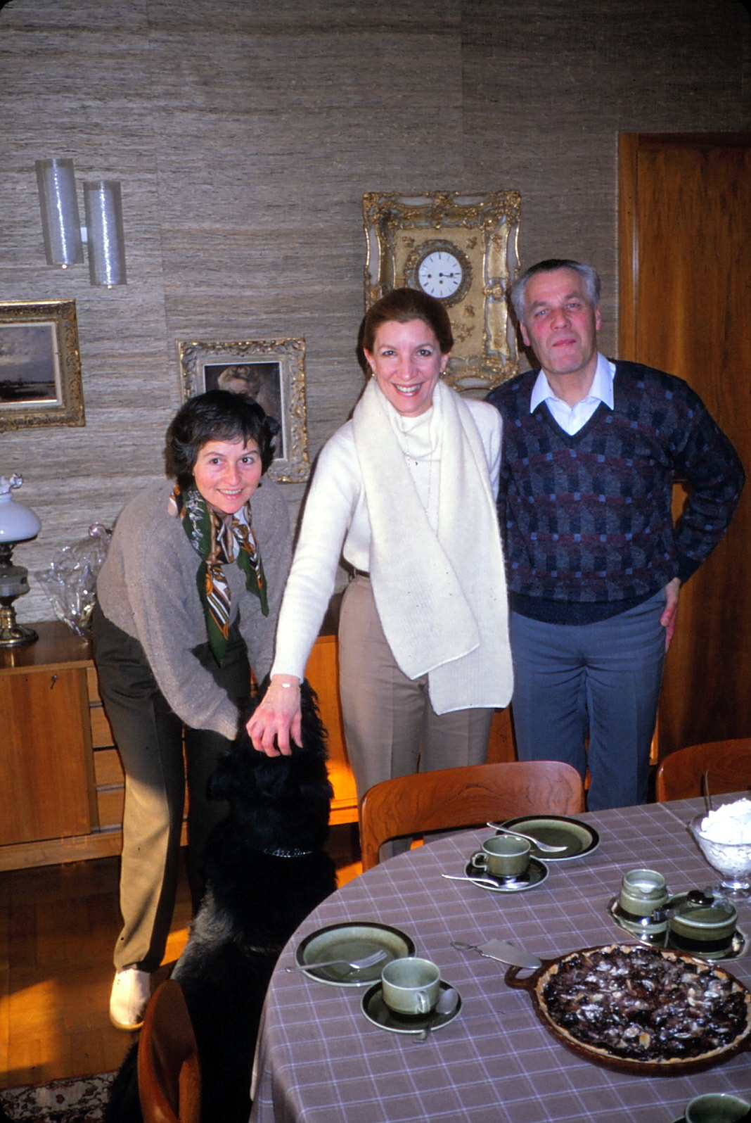 a group of people standing at the table together