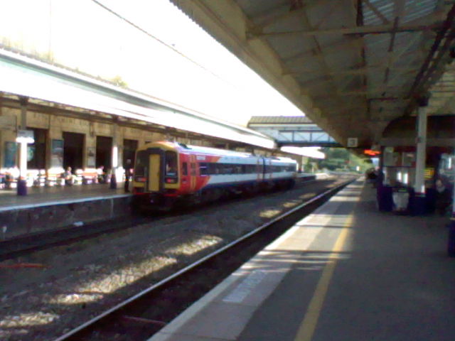 a passenger train is pulling into a station