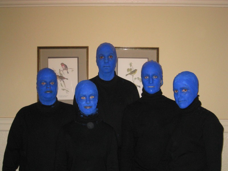 four blue men are wearing black clothing