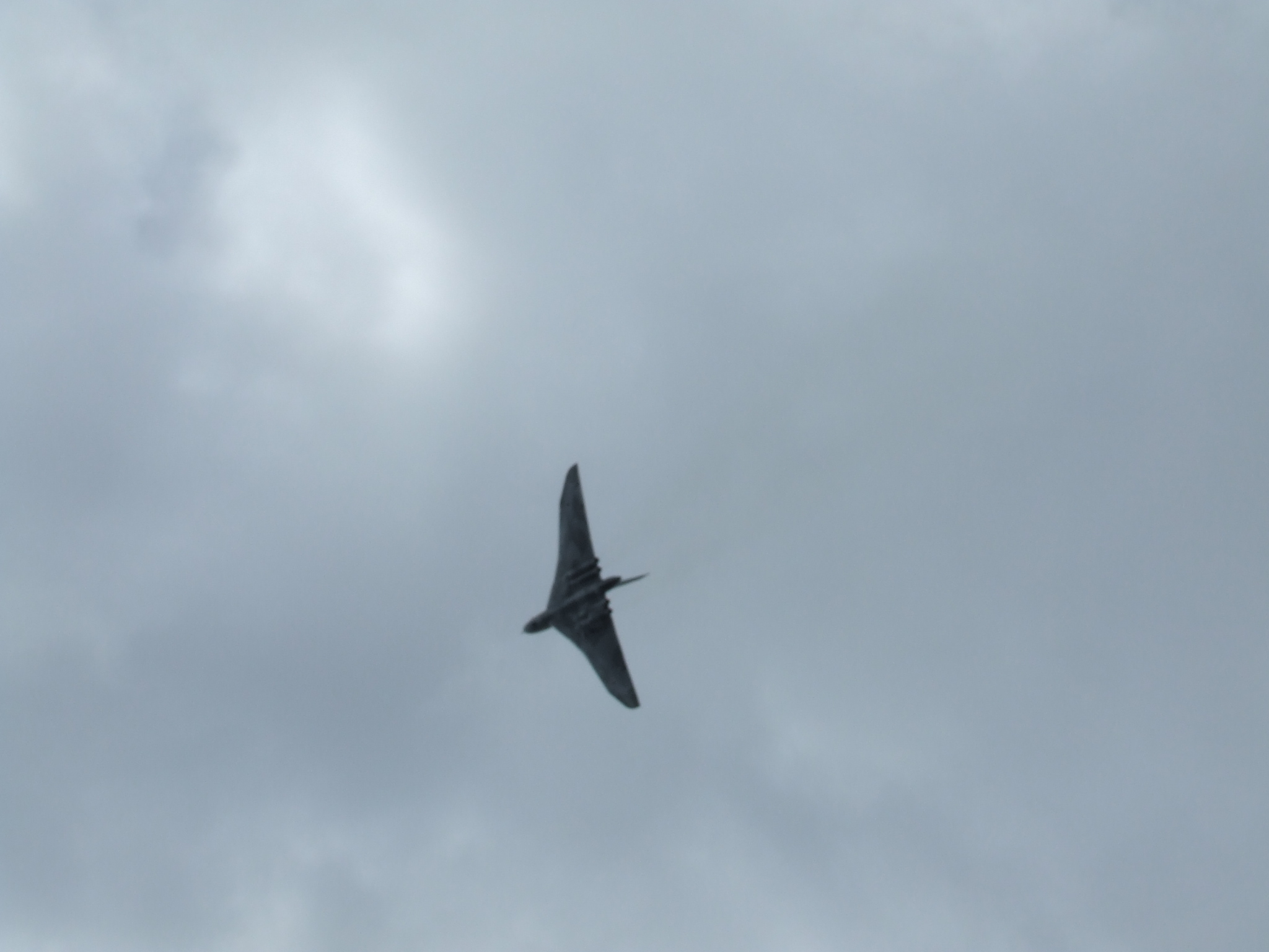 a jet flying in the cloudy sky