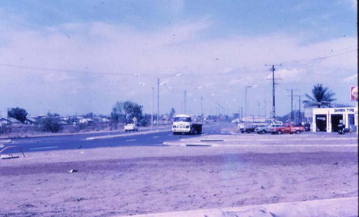 an older time picture with trucks and a gas station