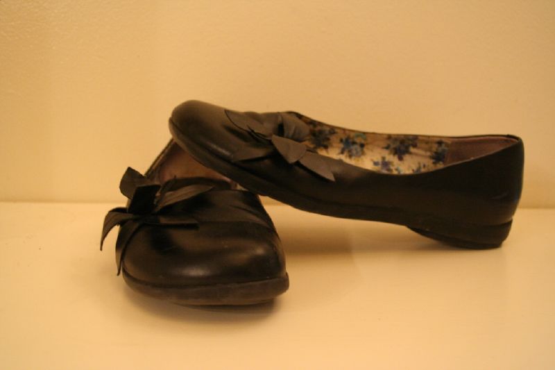 there is a pair of black shoes with bows