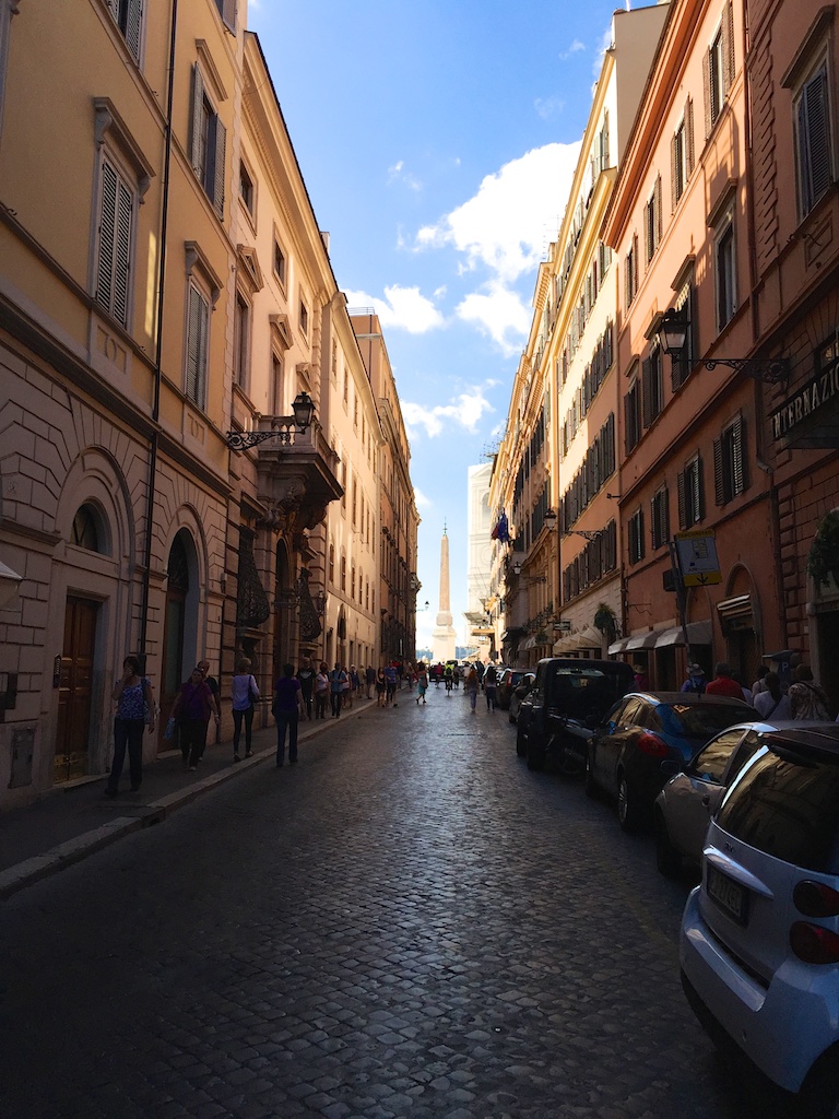 a row of tall buildings with windows on a street