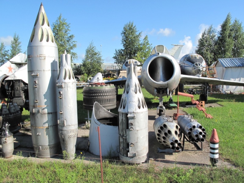 a bunch of airplanes and rockets that look like they are outside