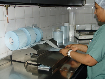a woman preparing food in a commercial kitchen