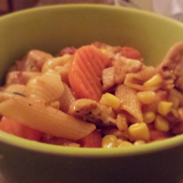 a green bowl with food in it on a table