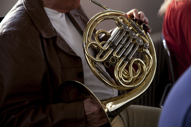an older man plays an instrument in a jazz band