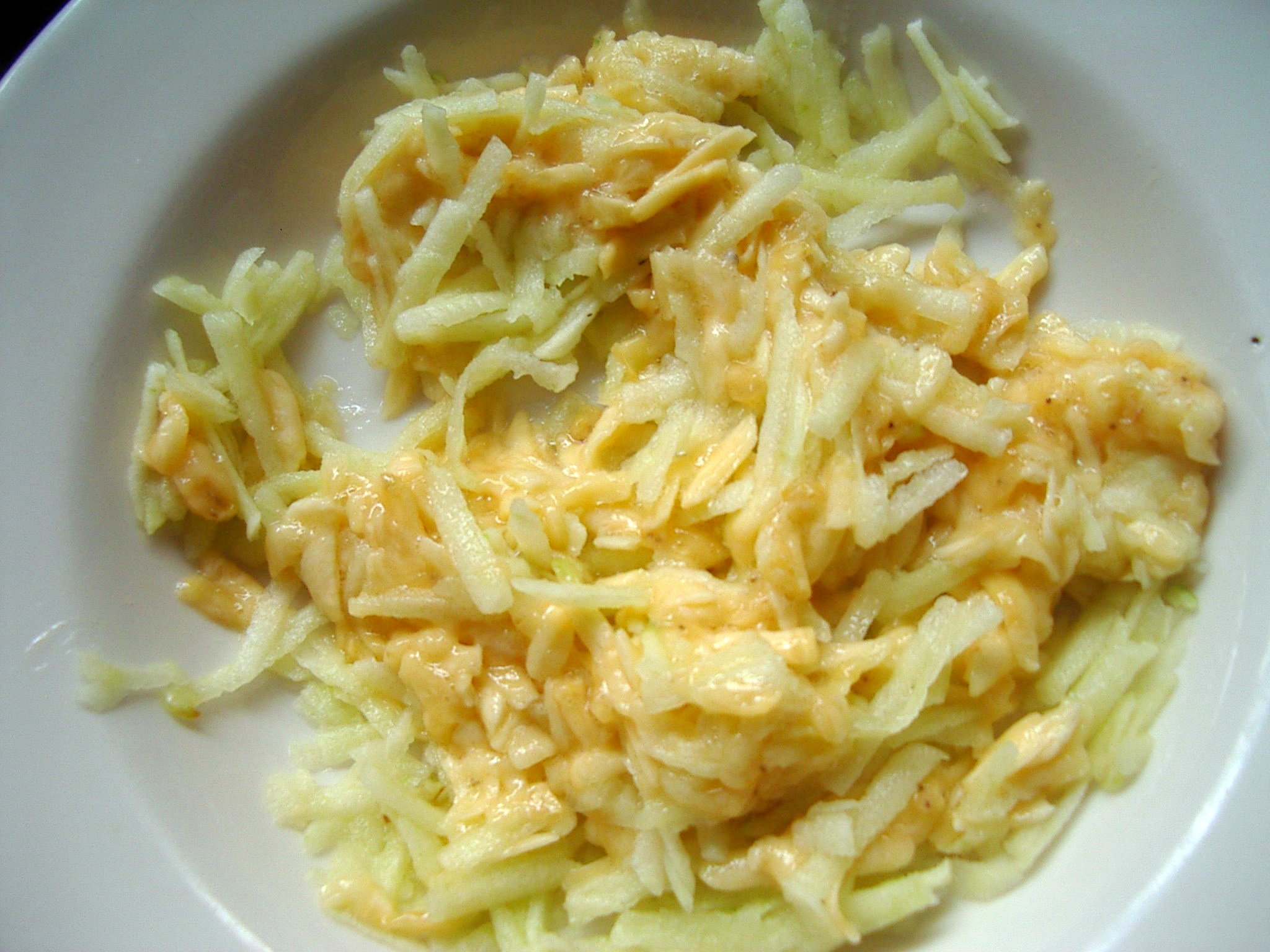 pasta on white plate with cheese and onions