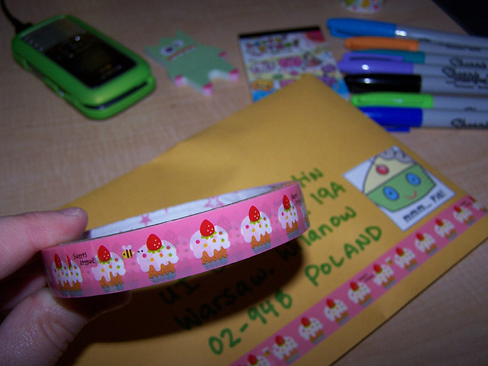 a hand holding a tape and some different stationery items