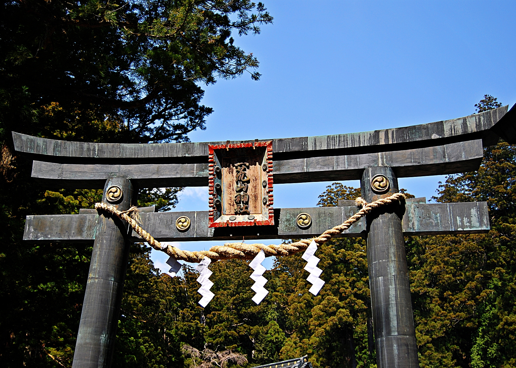 a wooden gate with rope hanging from it
