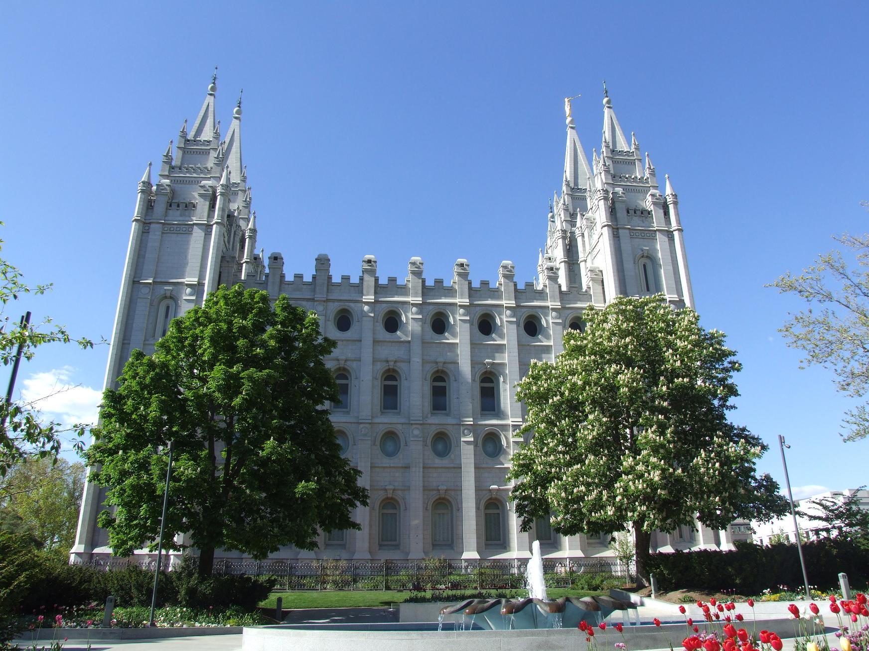 a large white building with two towers is set against a blue sky