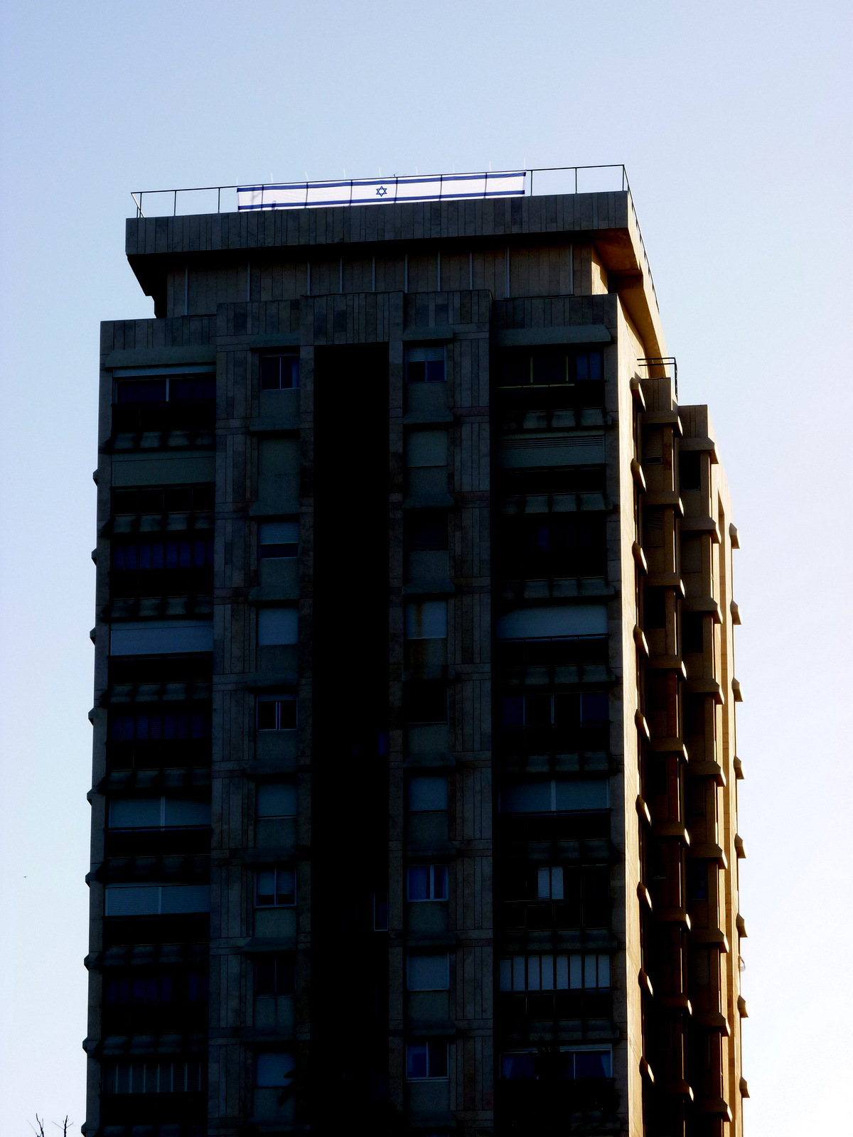 a tall building in the foreground with a sky background