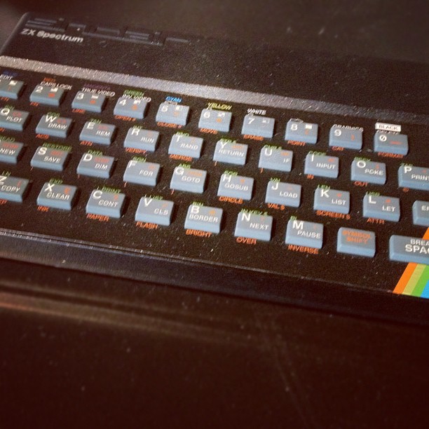 an old computer keyboard with many colorful keys on the keys