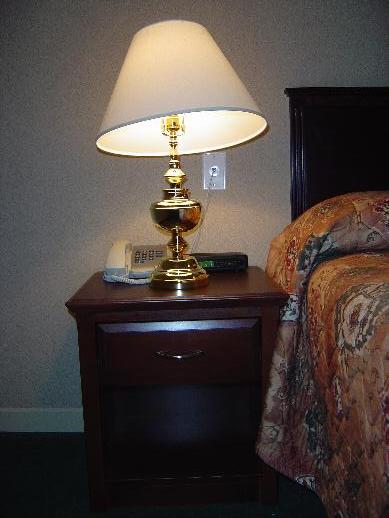 two nightstands side by side next to the bed