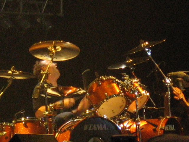 a drummer plays on the drums while performing