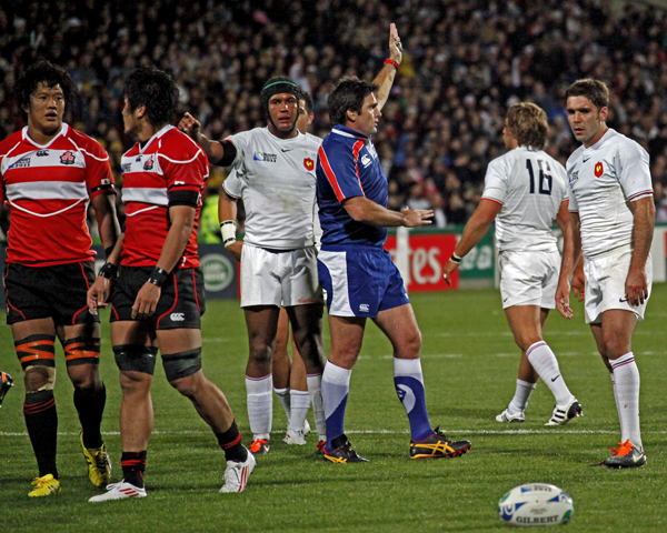 many rugby players are trying to kick the ball