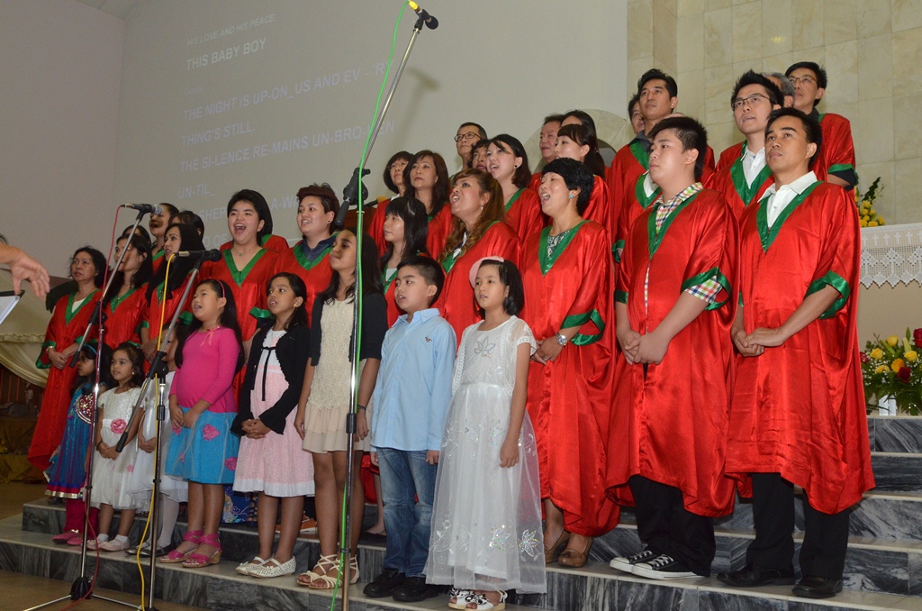 a group of people standing together with red gowns on