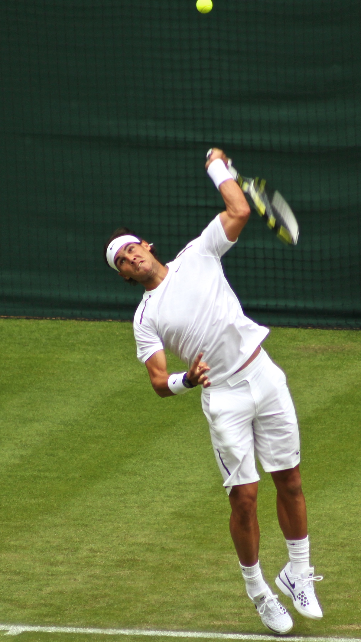 a tennis player who is hitting a ball with his racket