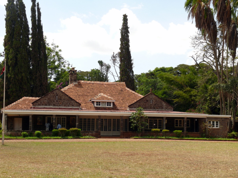 the house in the field is surrounded by many trees