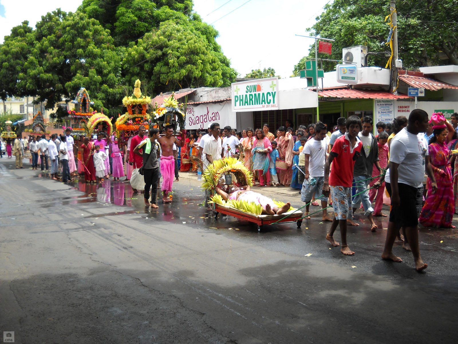 a parade with men, women and children taking a ride in a dragon boat