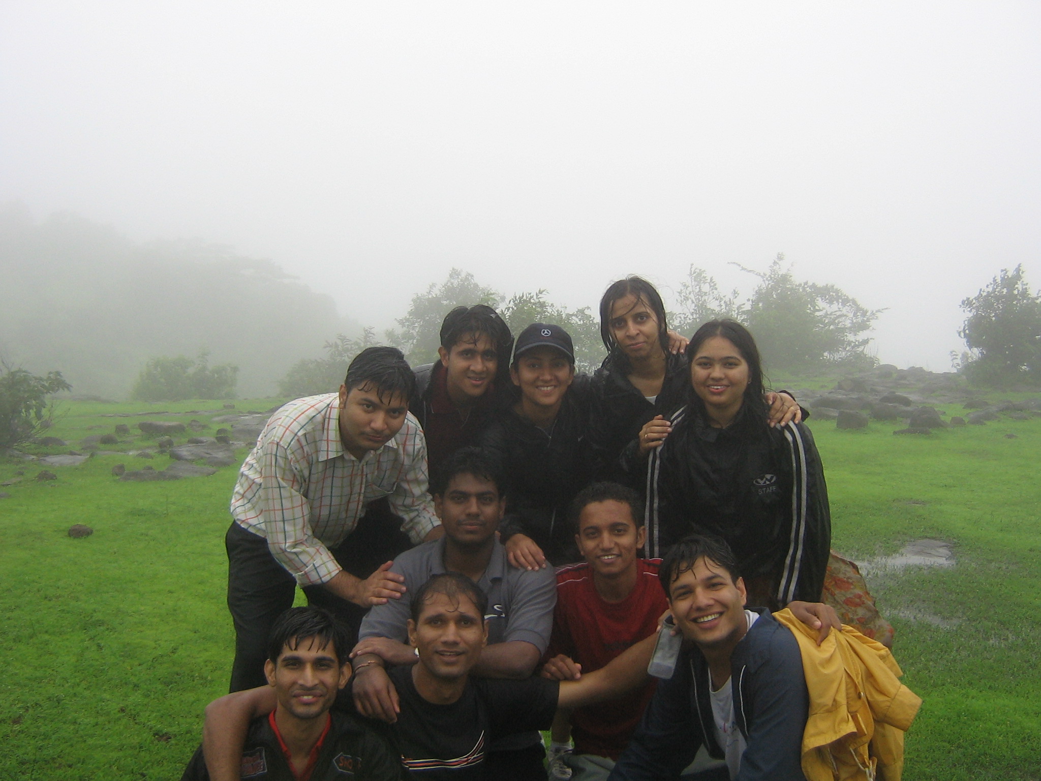 group of people posing in the middle of a foggy field
