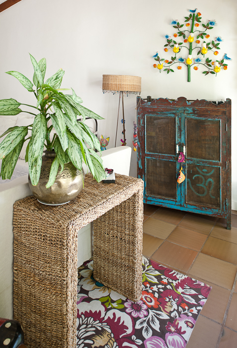 a large plant is in front of a wooden cabinet