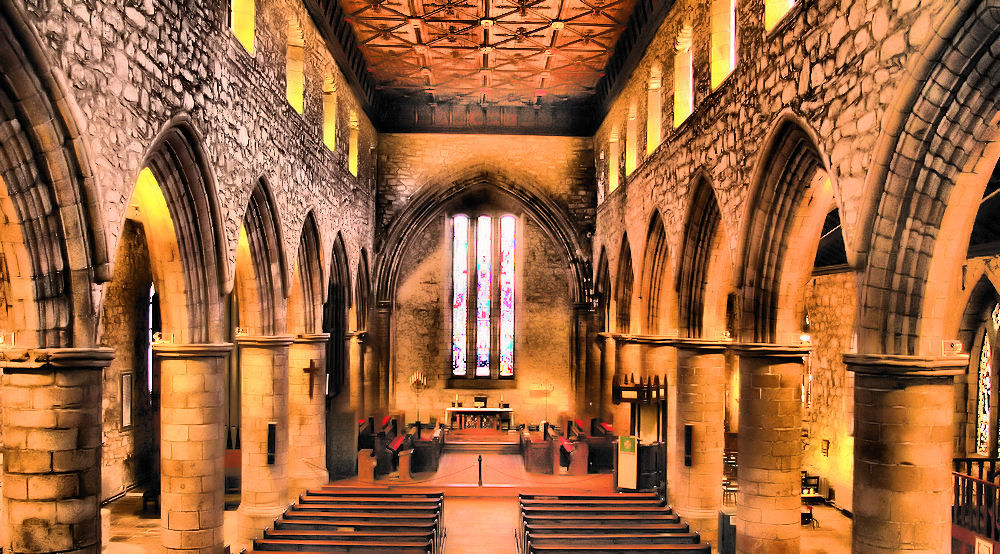 an old church with stained glass and stone walls