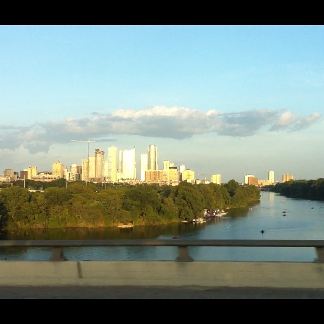 view of a city skyline and river from the highway