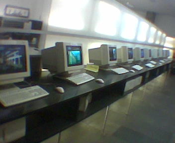 this computer desk is full of computers with monitors, and keyboards