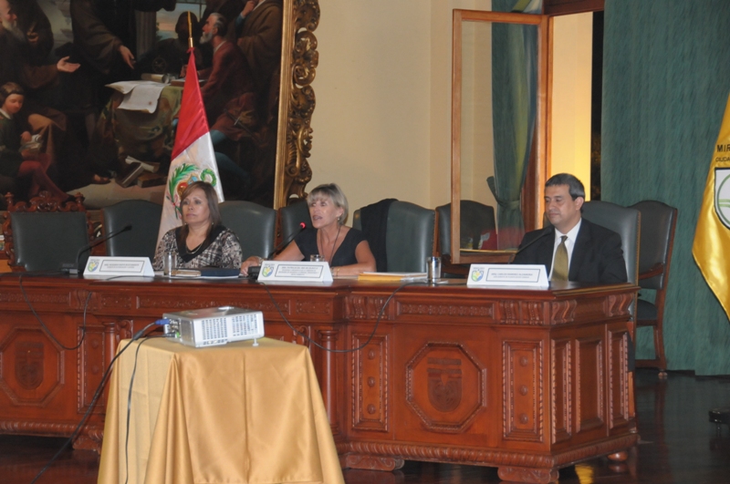 a group of people sitting at a wooden table