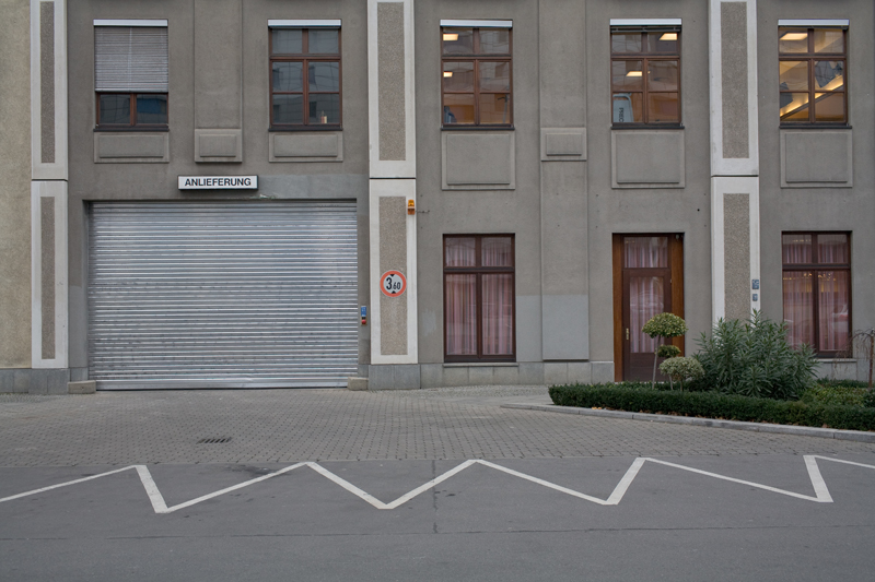 a large brown building with shutters open