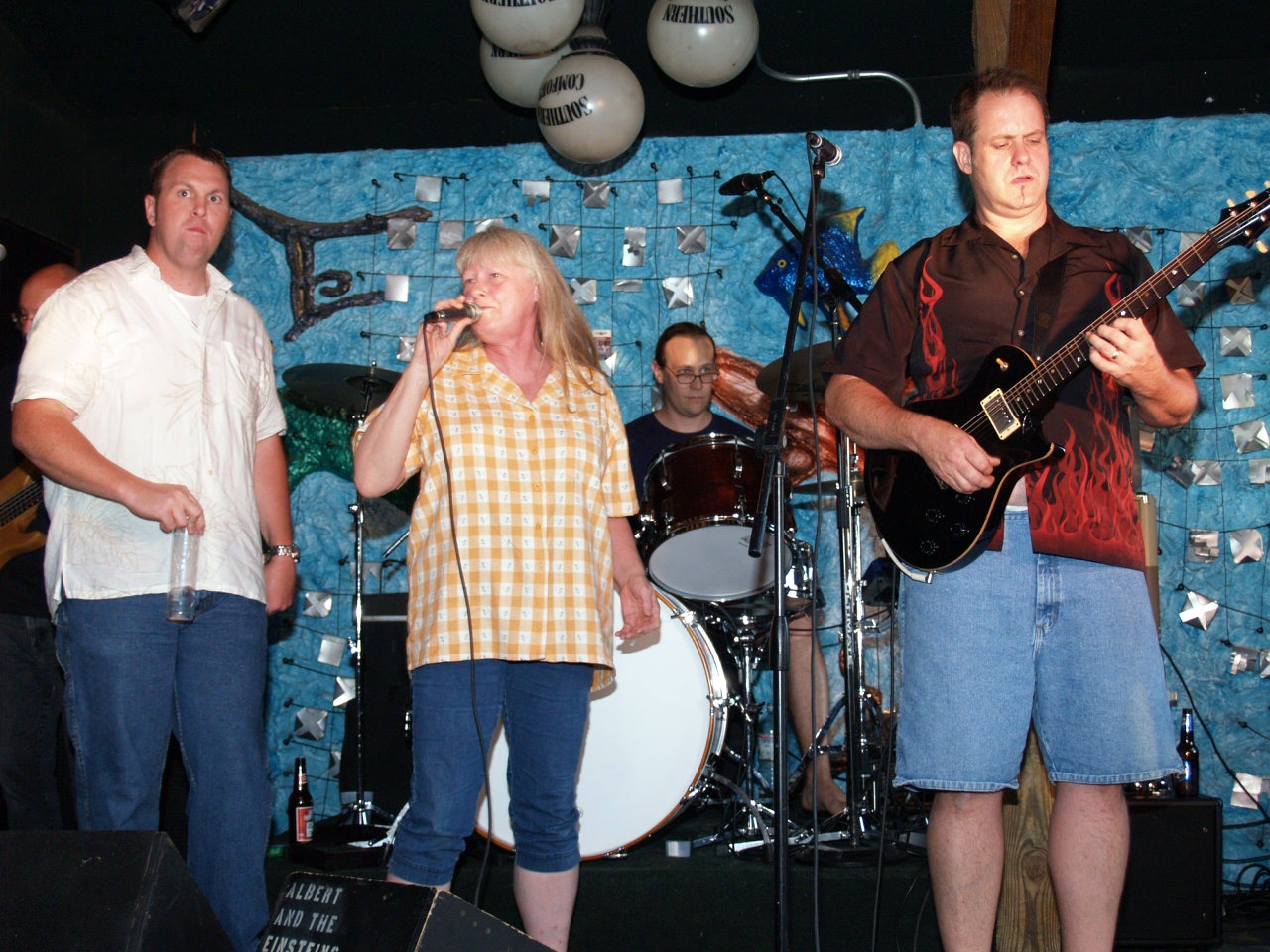 a band playing music at a party in front of a crowd